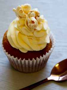 chocolate cupcake with yellow icing on top